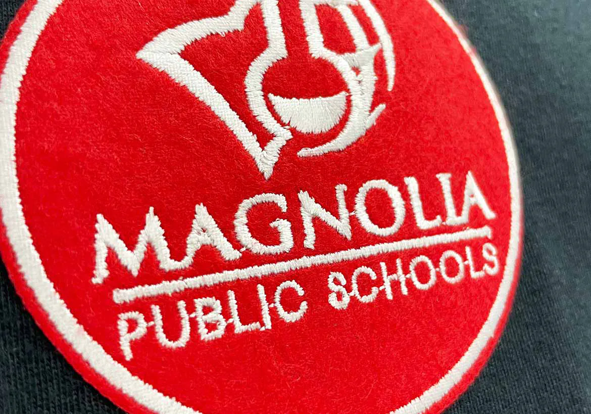 High-quality embroidery service stitching intricate logo on fabric, showcasing professional embroidery solutions for apparel branding – Custom Apparel, Screenprinting, and Embroidery services in Los Angeles.