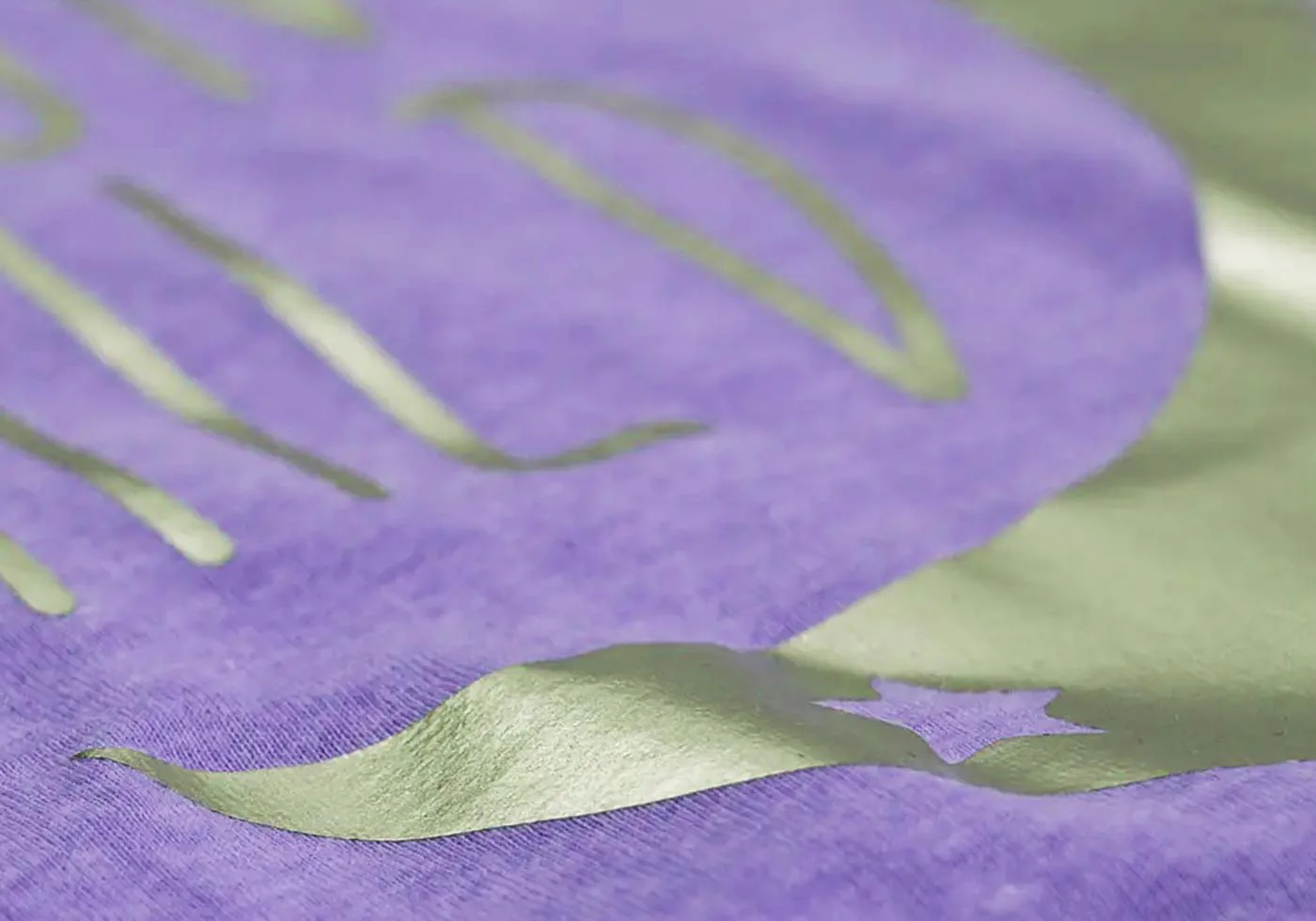 Custom apparel with special reflective printing effect on purple fabric – eco-friendly screen printing technique for unique t-shirt designs.